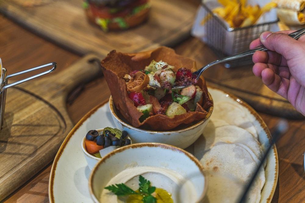 Doubletree By Hilton Doha - Al Sadd Hotel Exterior photo A Greek salad served in a pita